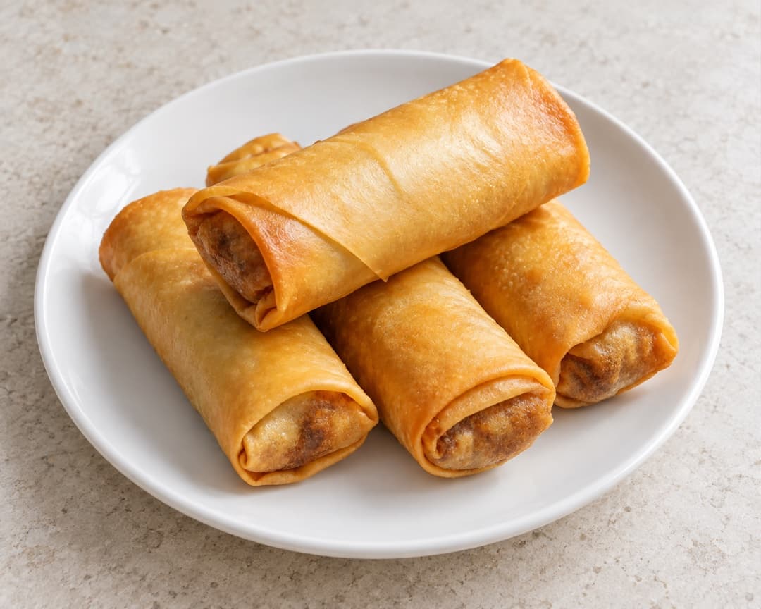 Crisp Big Mac popia spring rolls stacked on a plate